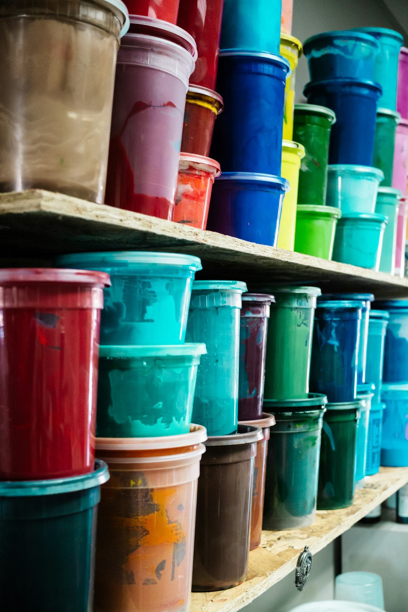 Industrial lacquer and paint containers on shelves